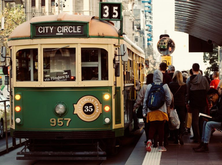 Passengers boarding the green number 35 tourist tram