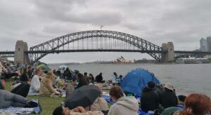 people camped out on Blues Point, looking out to the Sydney Harbour Bridge on New Year's Eve